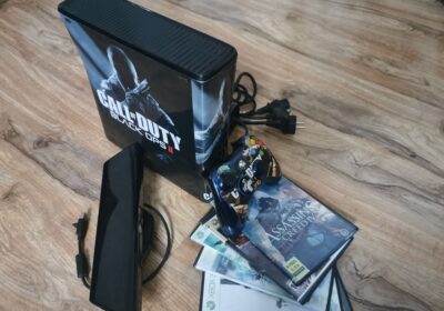 Dodo emblem on a vintage metal box with gaming accessories and DVDs