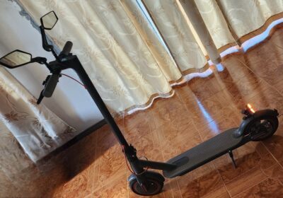 Electric scooter, black color, compact design, suitable for urban commuting. Ideal for quick, eco-friendly travel around Mauritius.