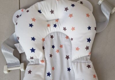 Baby head support cushion with star pattern, white background, for car seats and strollers.