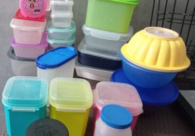 Plastic food storage containers set with colorful lids, including round and rectangular shapes, ideal for kitchen organization and meal prep.