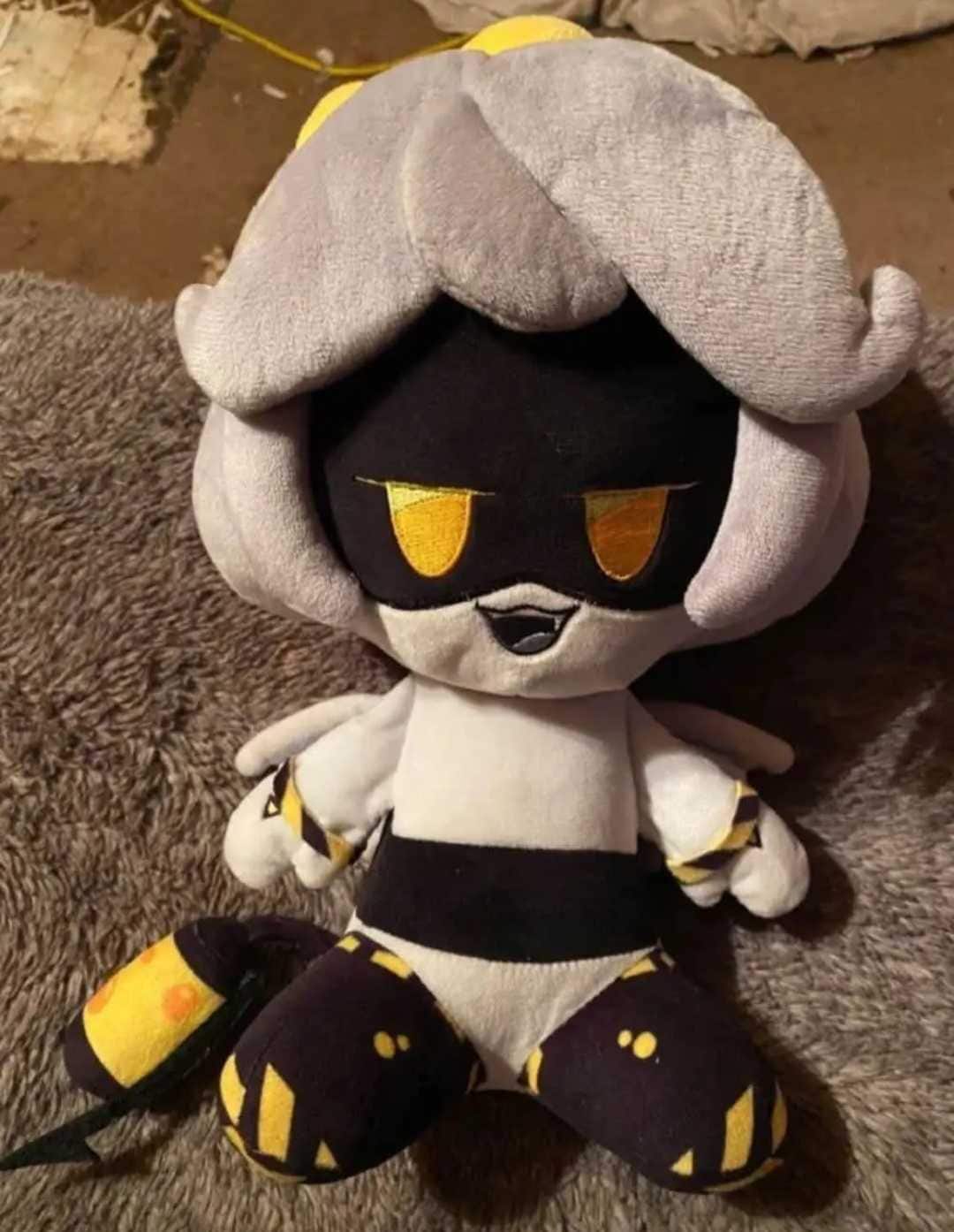 Plush toy of a character with gray hair, black mask, and yellow details, perfect for collectors or as a gift.
