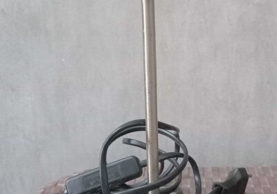 Table lamp with white socket and black power cord, used for interior lighting.