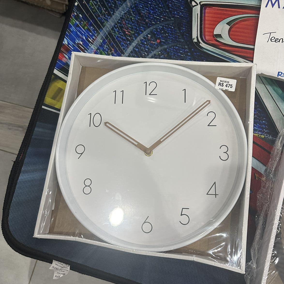 Elegant white round wall clock with beige hands, modern design, perfect for home or office use.