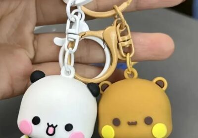 Cute panda and lion keychains with small bear accessories, in white and brown colors, attached to key rings.