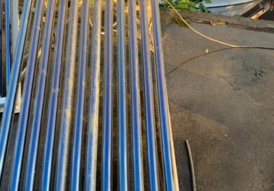 Solar water heater with stainless steel tubes, silver color, for efficient heating.