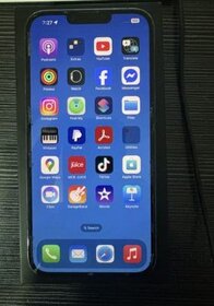 Smartphone with colorful app icons on screen, black case, on a textured black surface.