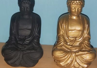 Vintage Buddha statues, black and gold, sitting cross-legged, decorative indoor ornaments.