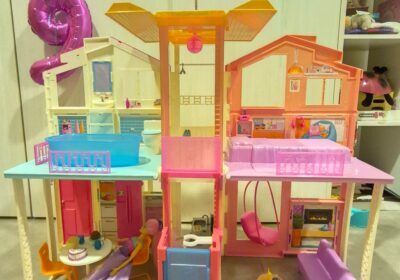 Colorful dollhouse with multiple rooms and furniture for children