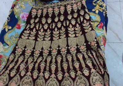 Elegant traditional Mauritian dress with intricate gold embroidery, deep maroon color, suitable for special occasions.