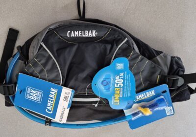 CamelBak hydration pack with blue water bladder, black and gray backpack, and adjustable straps.