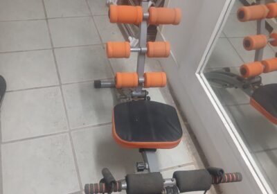 Compact adjustable dumbbell set with orange and black handles, suitable for home gym workouts.