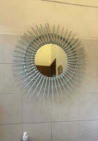 Mirror with a sunburst frame, silver color, decorative wall mirror.