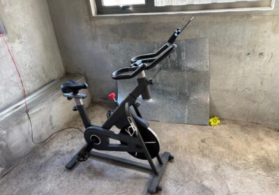 Indoor exercise bike in black with digital display and adjustable seat, ideal for home workouts.