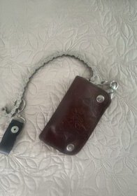 Key holder with leather case, brown color, and metal chain.