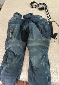 Motorcycle riding pants, blue denim, reinforced for safety, with zippers and pockets, suitable for motorcycle enthusiasts.