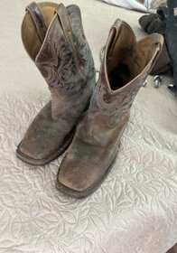 Vintage brown leather cowboy boots with intricate stitching and pointed toes.