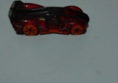 Miniature red toy sports car, plastic model, detailed design, perfect for collectors and children.