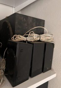 Car audio speakers set with wires, black color, rectangular shape, used for car sound system enhancement.